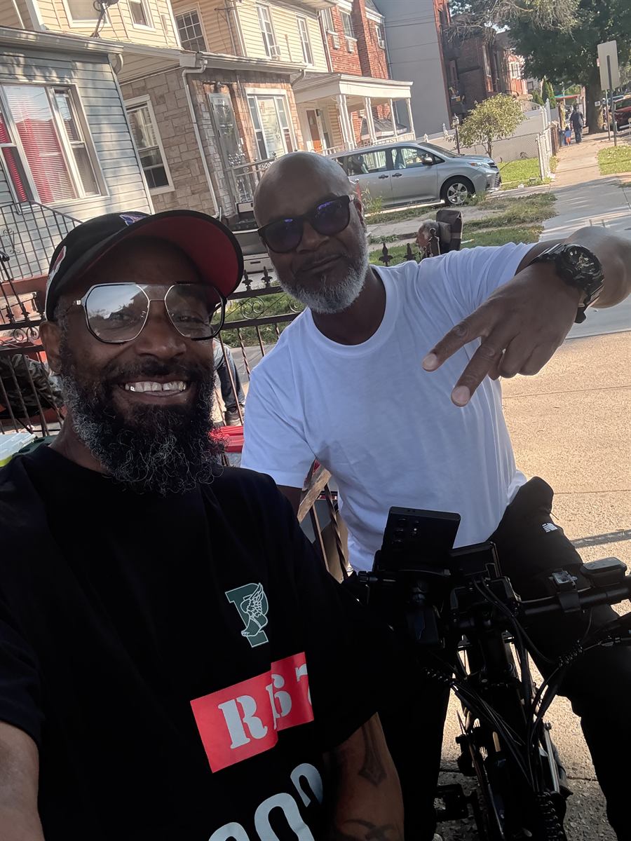 Prance with a neighbor in a white t-shirt, bikes parked on the street behind them
