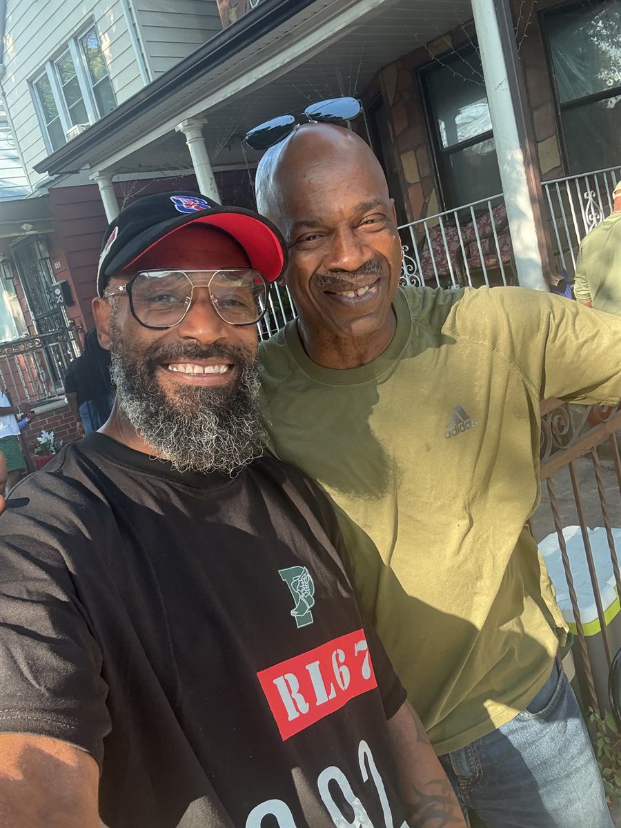 Prance with a neighbor in a yellow t-shirt in front of a porch on the avenue