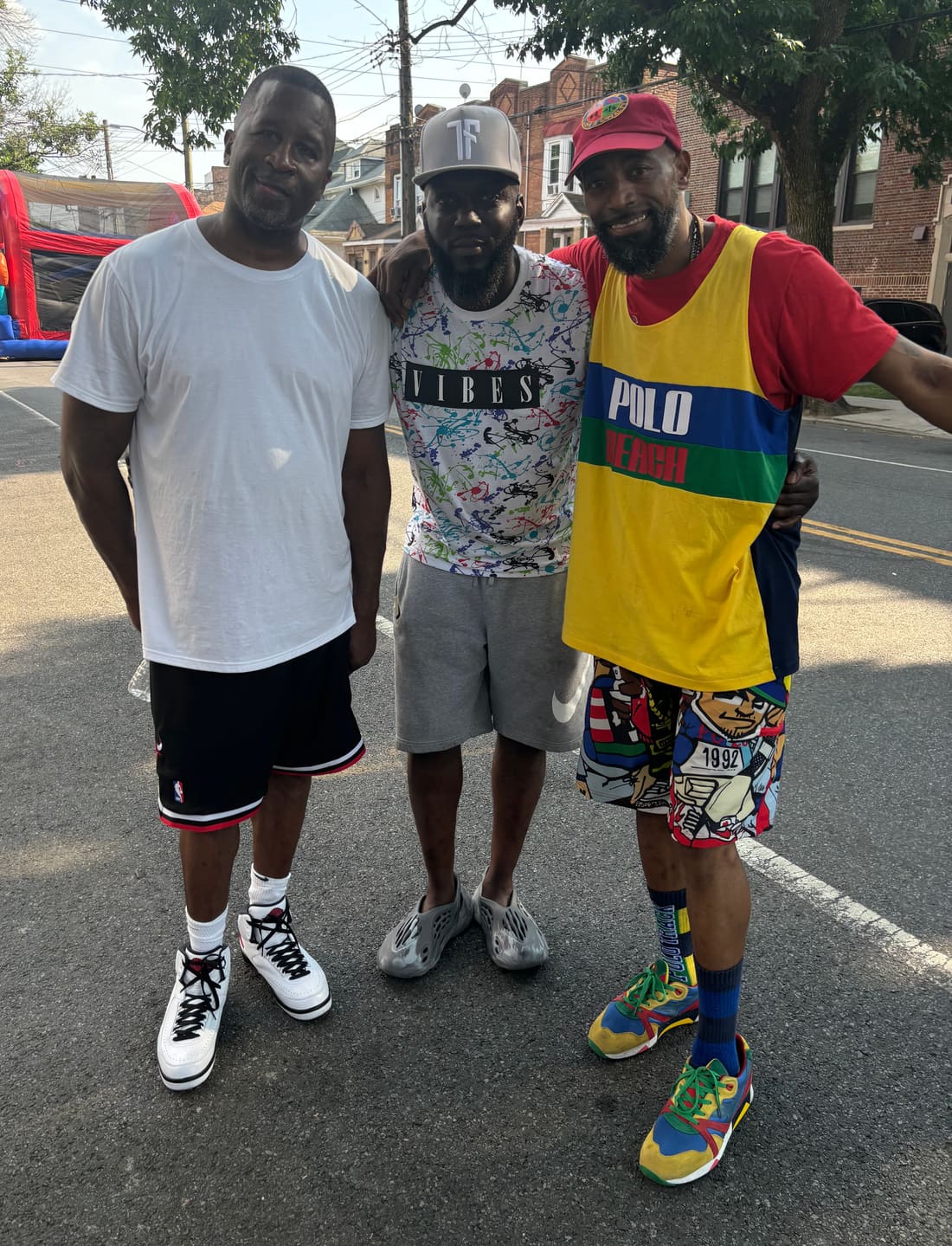 Lamont, Donovan and Prance standing together in the middle of Albany Avenue at the block party