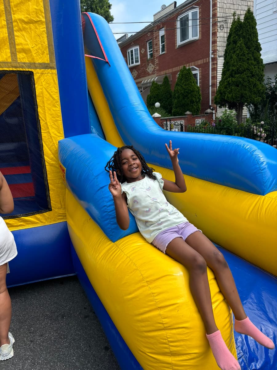 A kid coming down the inflatable slide